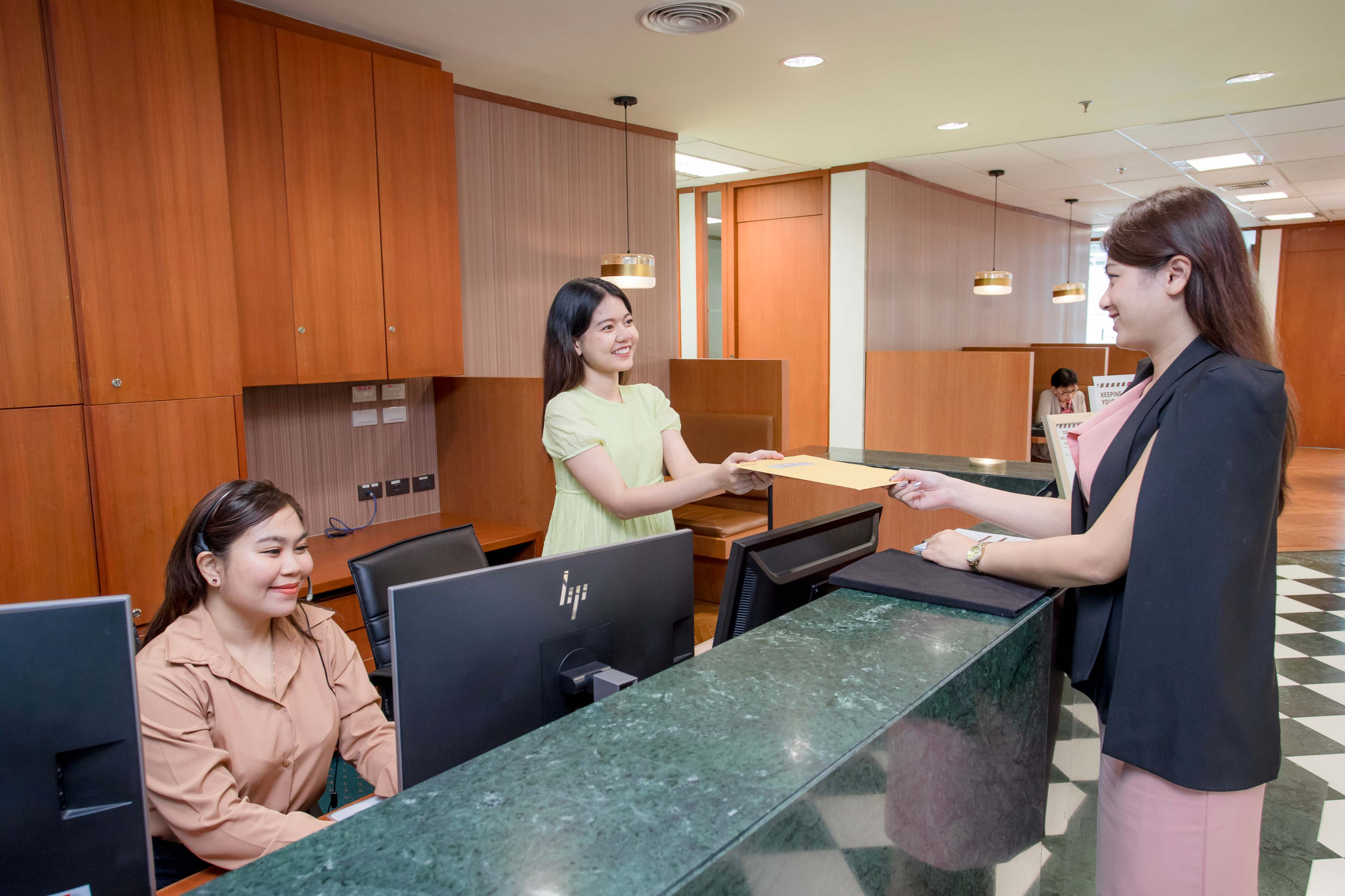 Receptionist helping clients at the front desk